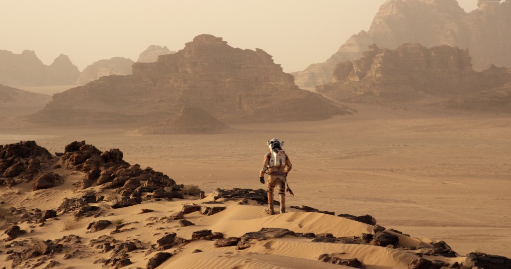 Astronaut Mark Watney traverses the Martian landscape in a scene from The Martian.